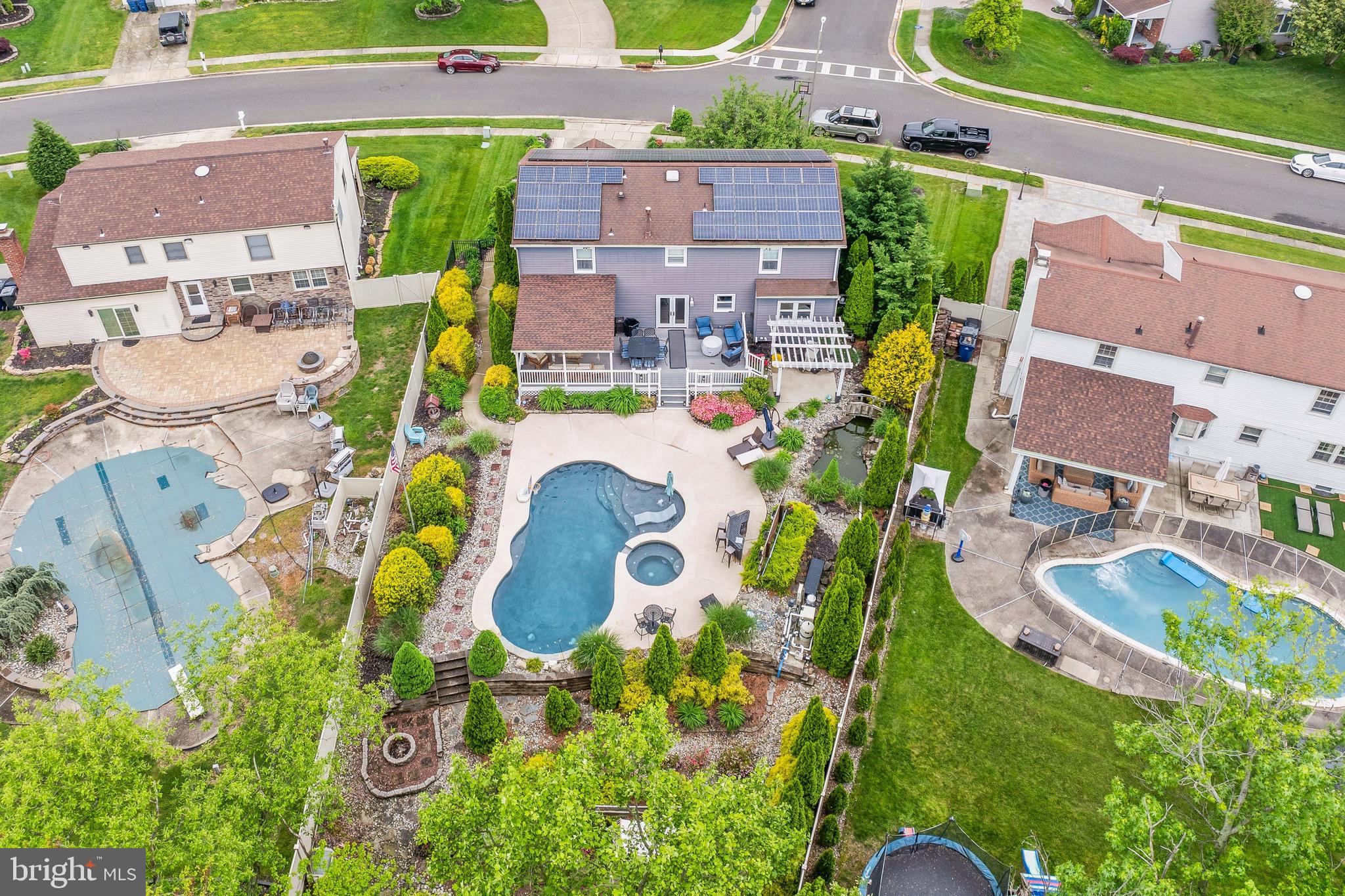 an aerial view of residential house with outdoor space and swimming pool