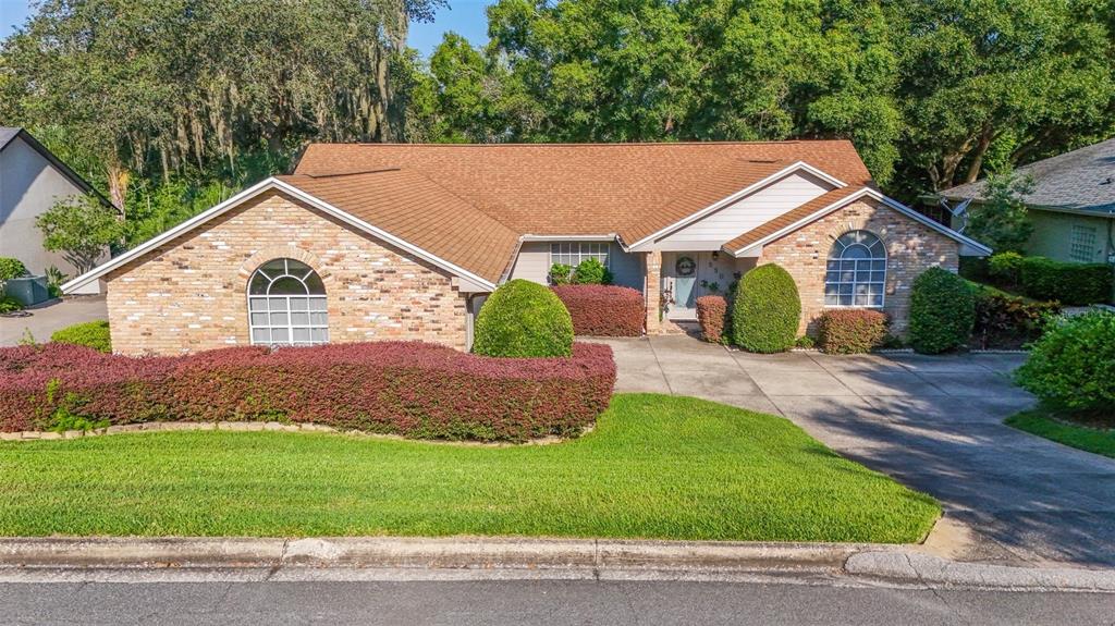 a aerial view of a house next to a yard