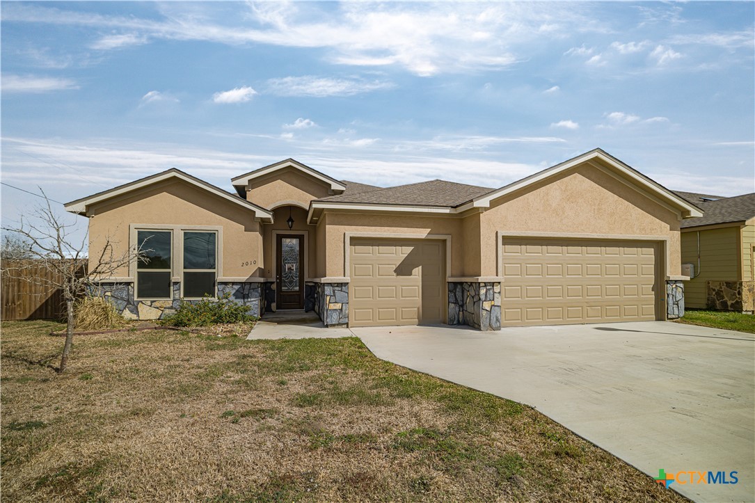 a front view of a house with yard outdoor seating and barbeque oven