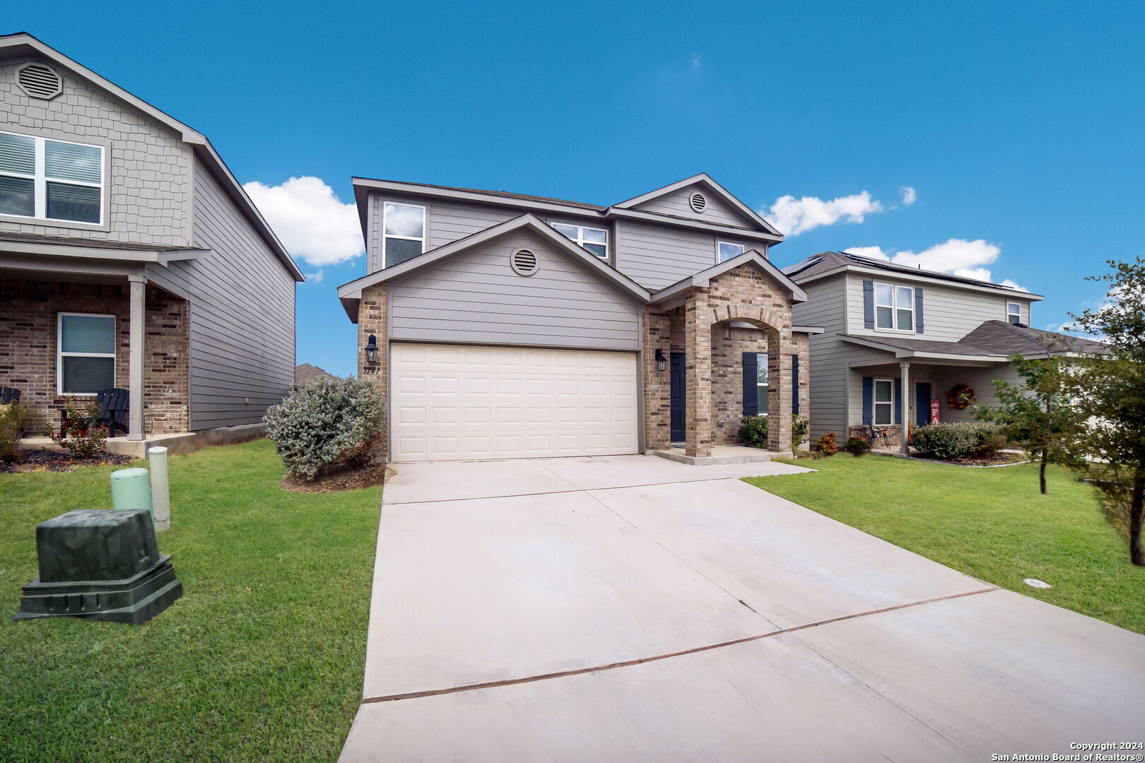 a front view of a house with a yard and garage