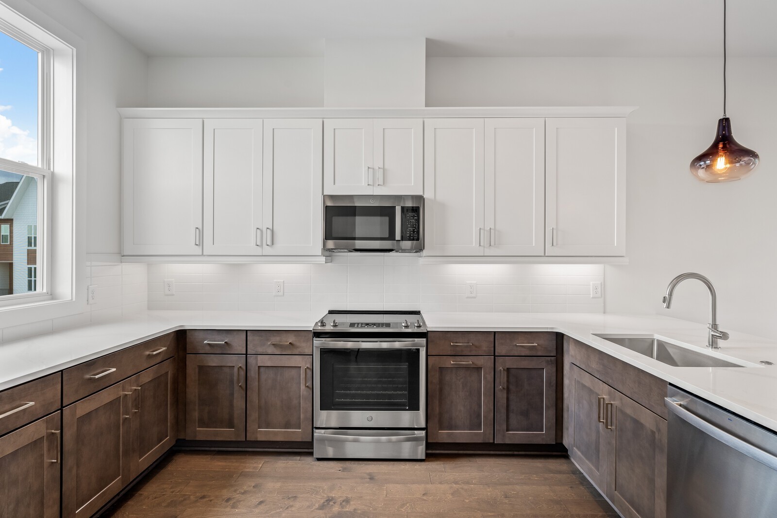 a kitchen with white cabinets stainless steel appliances and sink