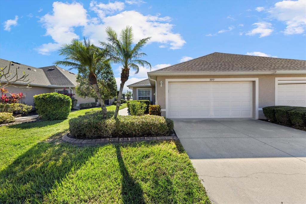 a front view of a house with a yard and garage