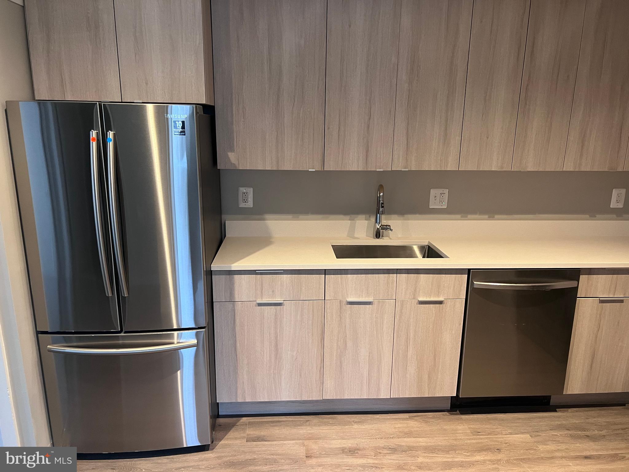 a kitchen with stainless steel appliances a refrigerator sink and cabinets