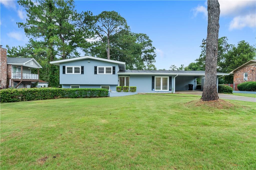 a front view of a house with a garden