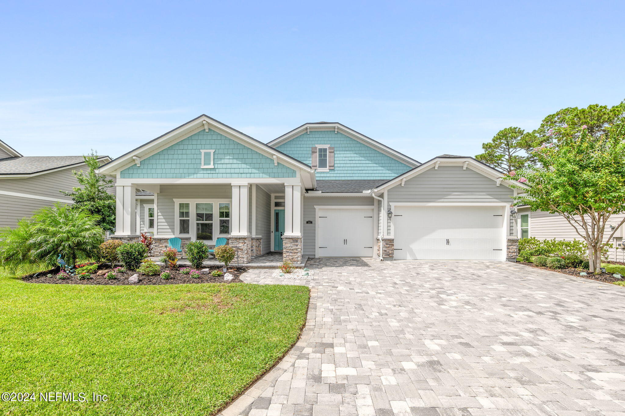 a front view of a house with a yard and outdoor seating