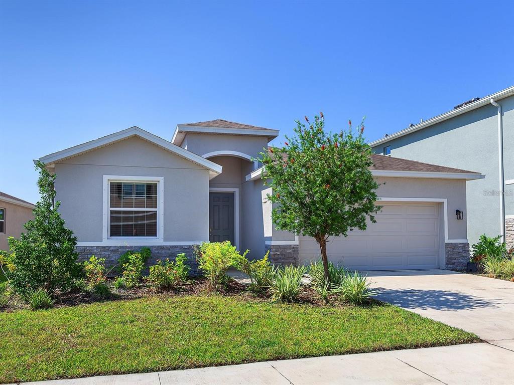 a front view of a house with a yard