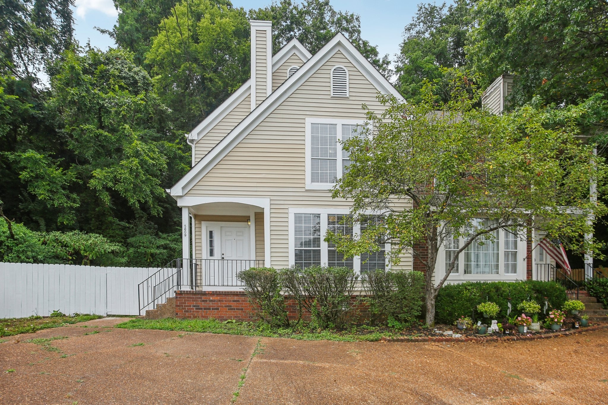 a view of a house with a yard and plants