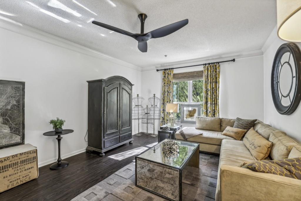 a living room with furniture a window and a chandelier