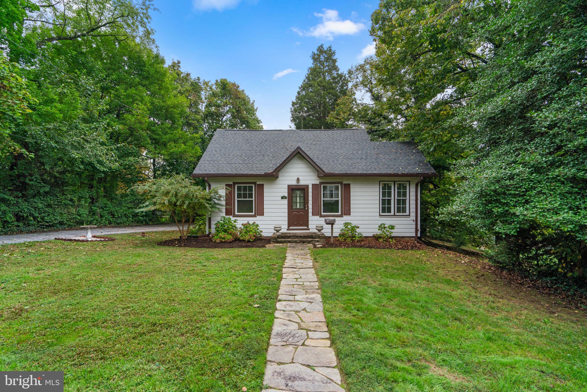 a front view of a house with yard patio and green space