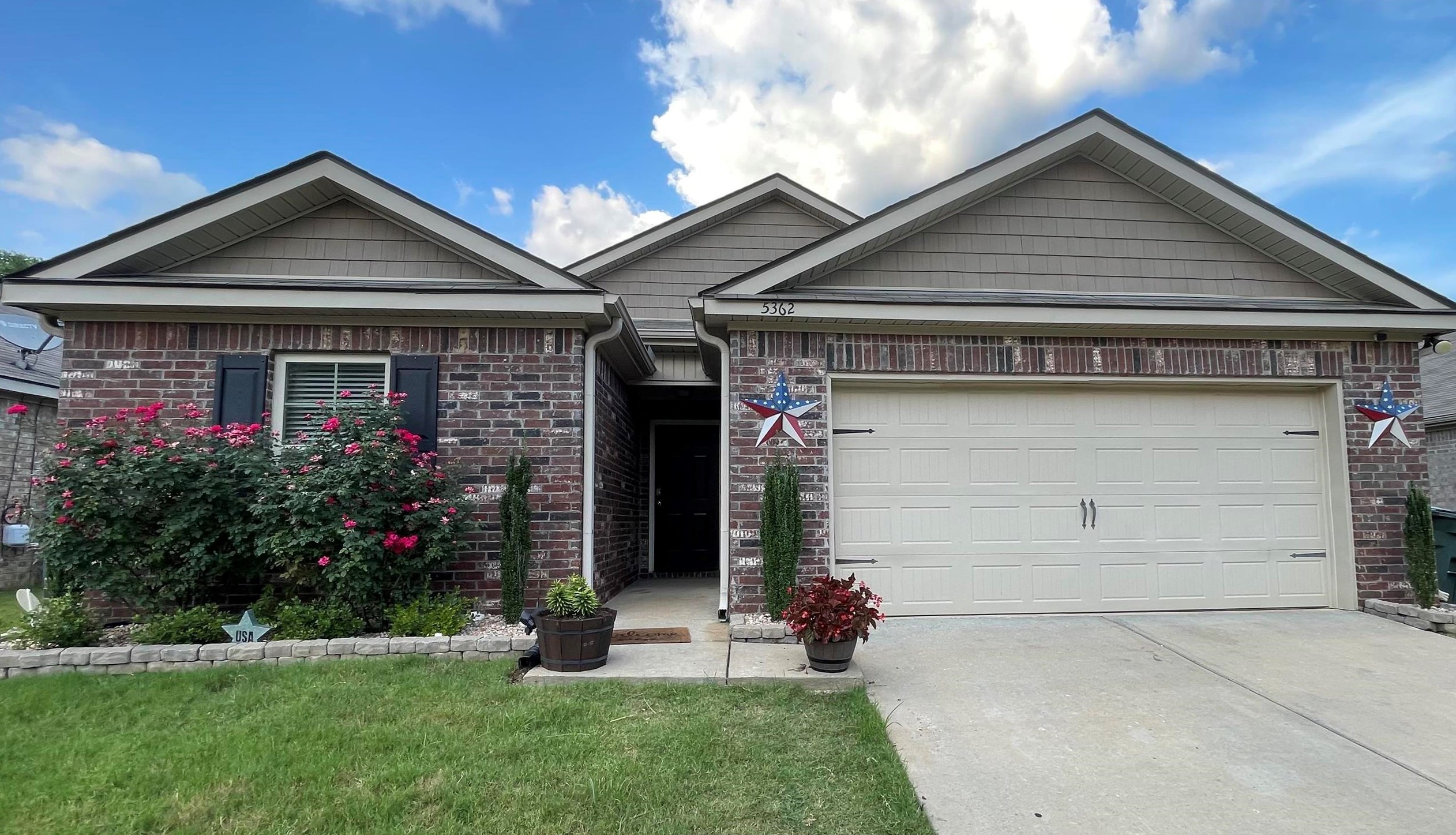 View of front of property with a garage and a front yard