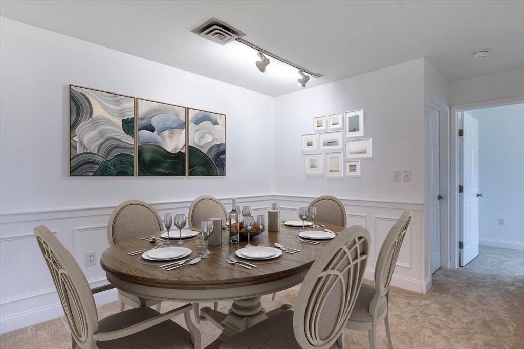 a dining room with furniture and wooden floor