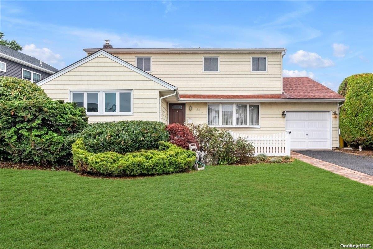 a front view of a house with a garden