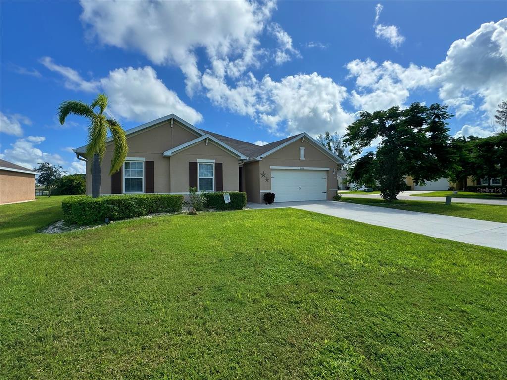 a front view of house with yard and green space