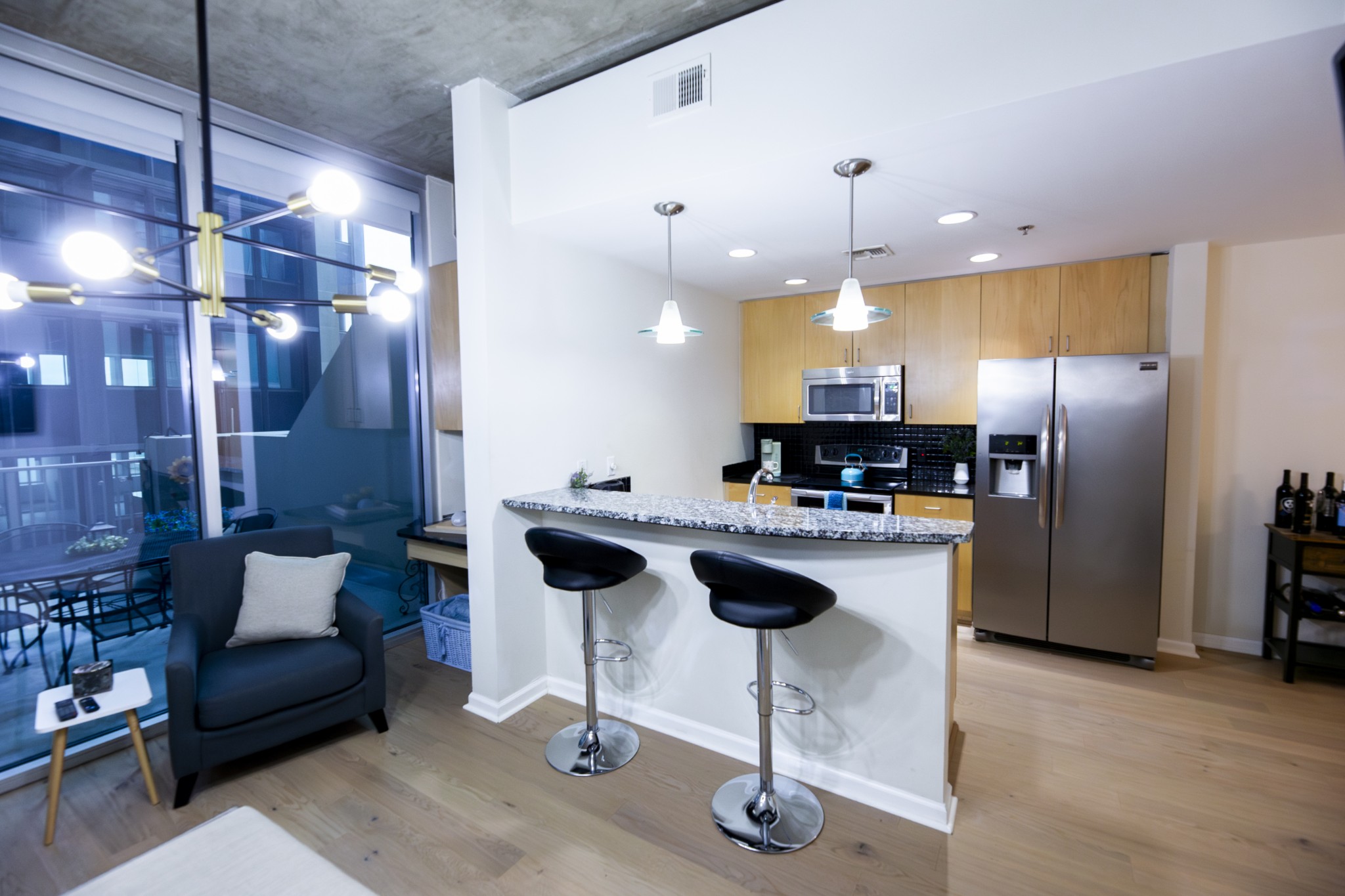 a kitchen with stainless steel appliances kitchen island a refrigerator and a wooden cabinets