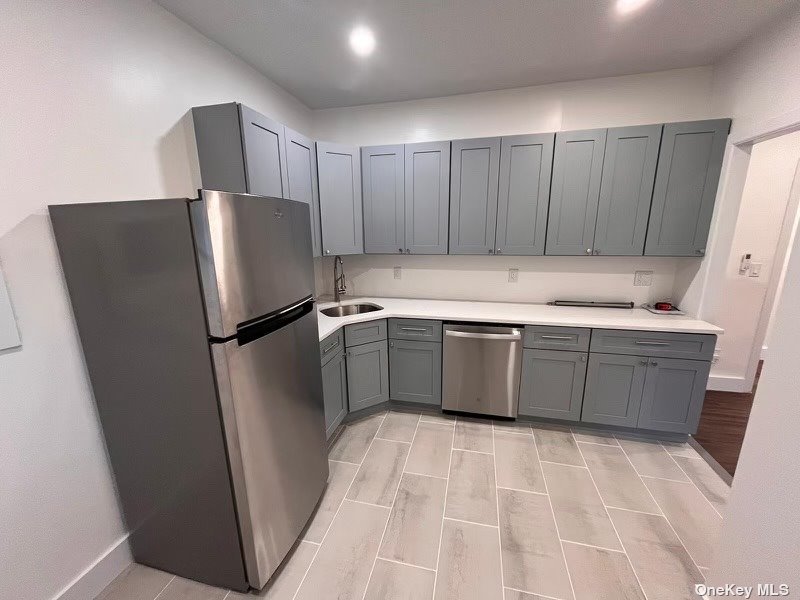 a kitchen with stainless steel appliances a refrigerator and a sink