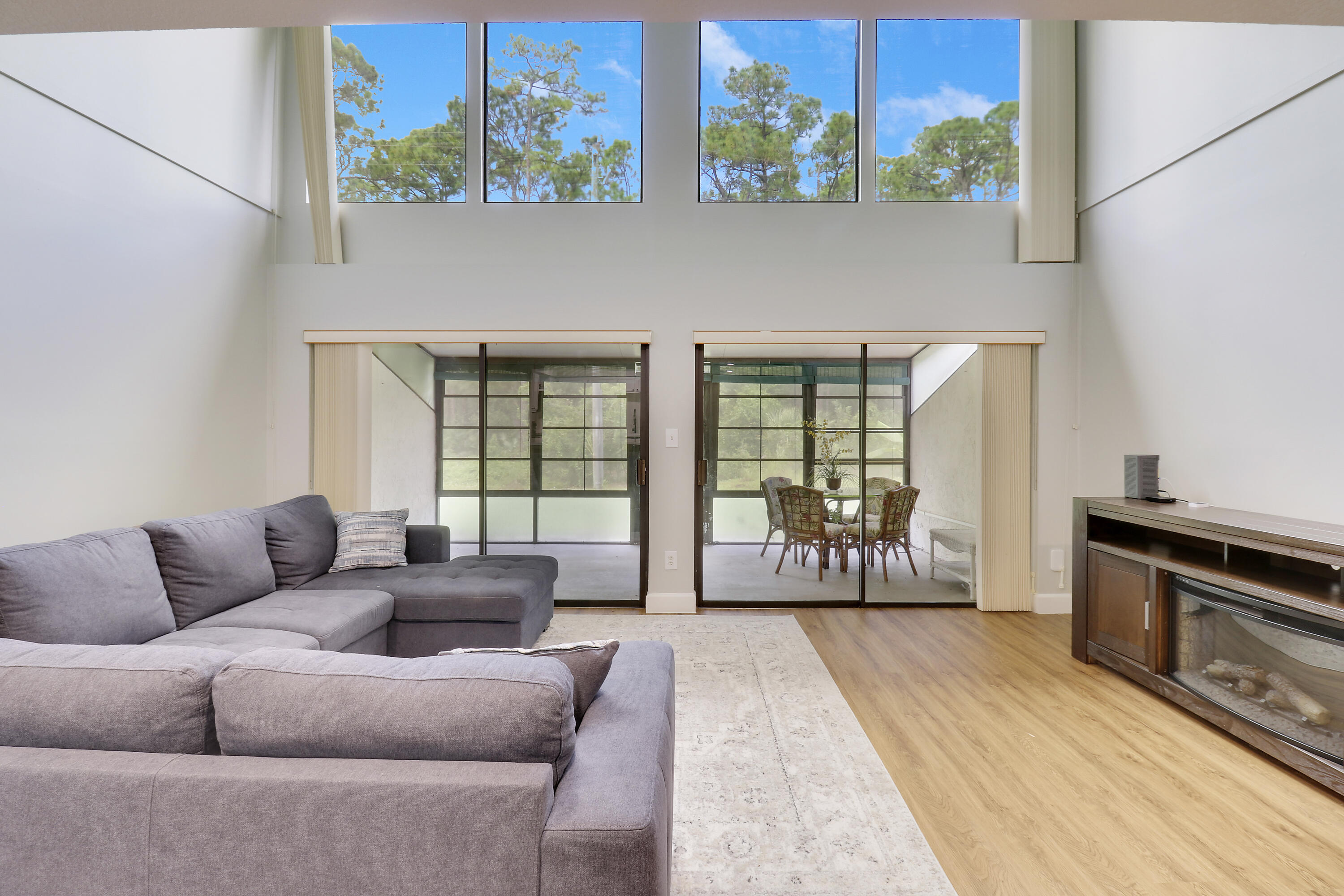 a living room with furniture and a floor to ceiling window