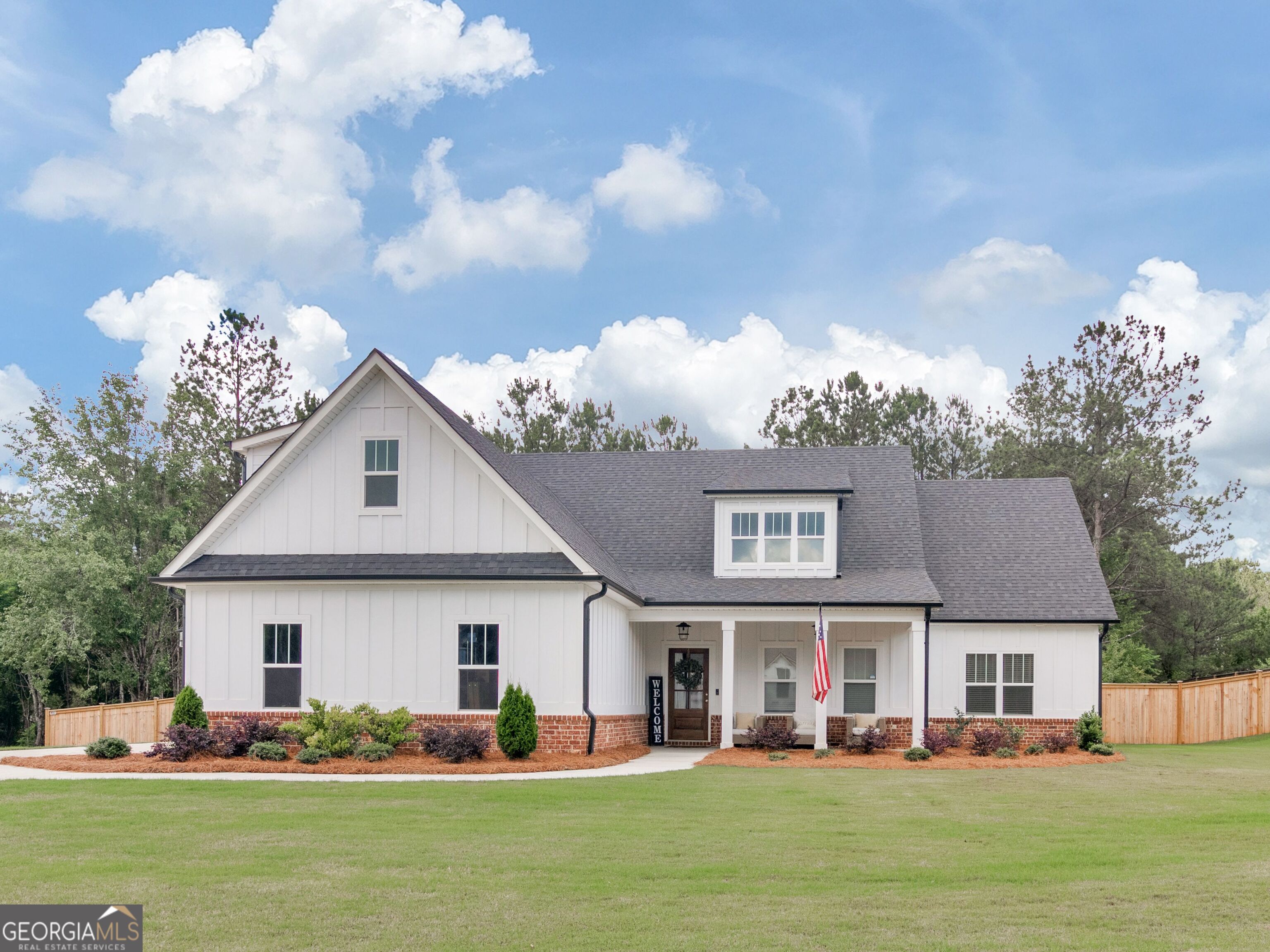 a front view of a house with garden