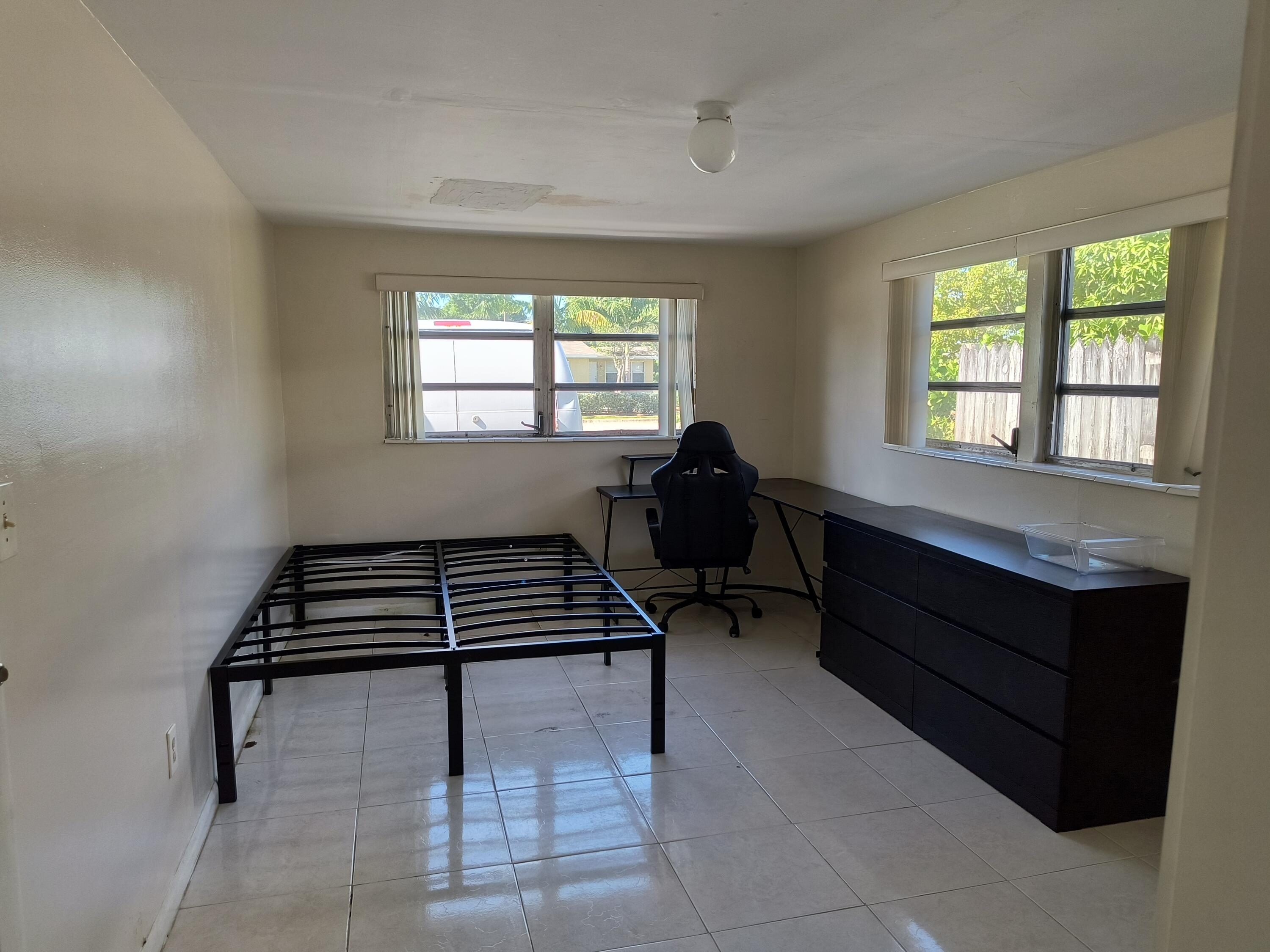 a bedroom with furniture and windows