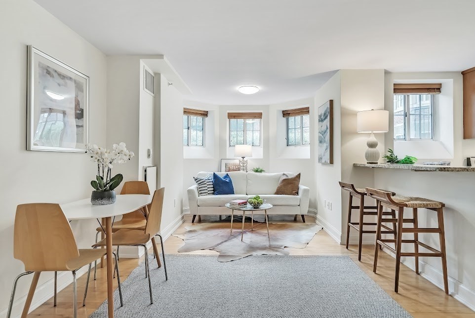 a living room with furniture and wooden floor