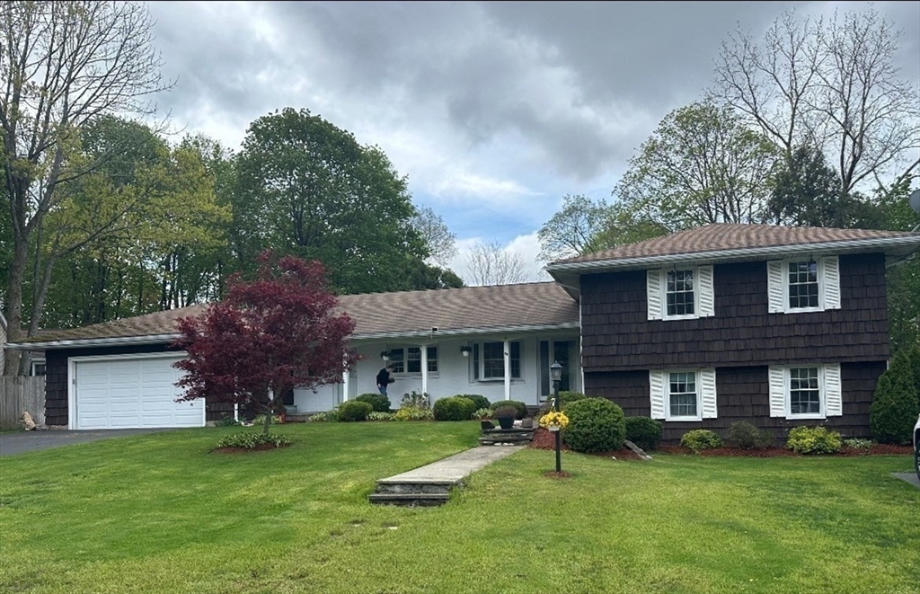 a front view of a house with a garden