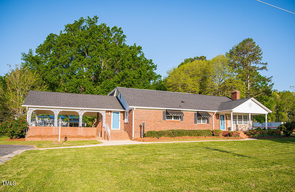 a front view of a house with a garden and porch