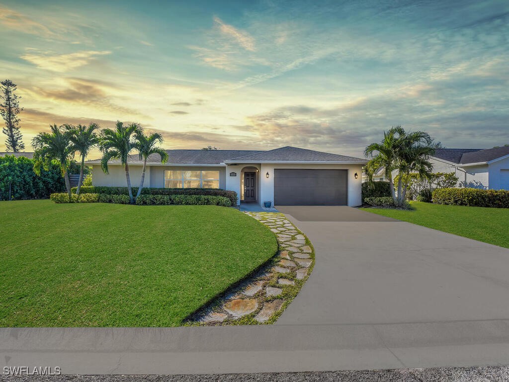 a front view of house with yard and green space