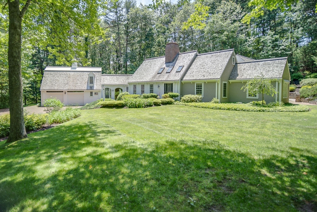 aerial view of a house with a yard and sitting area