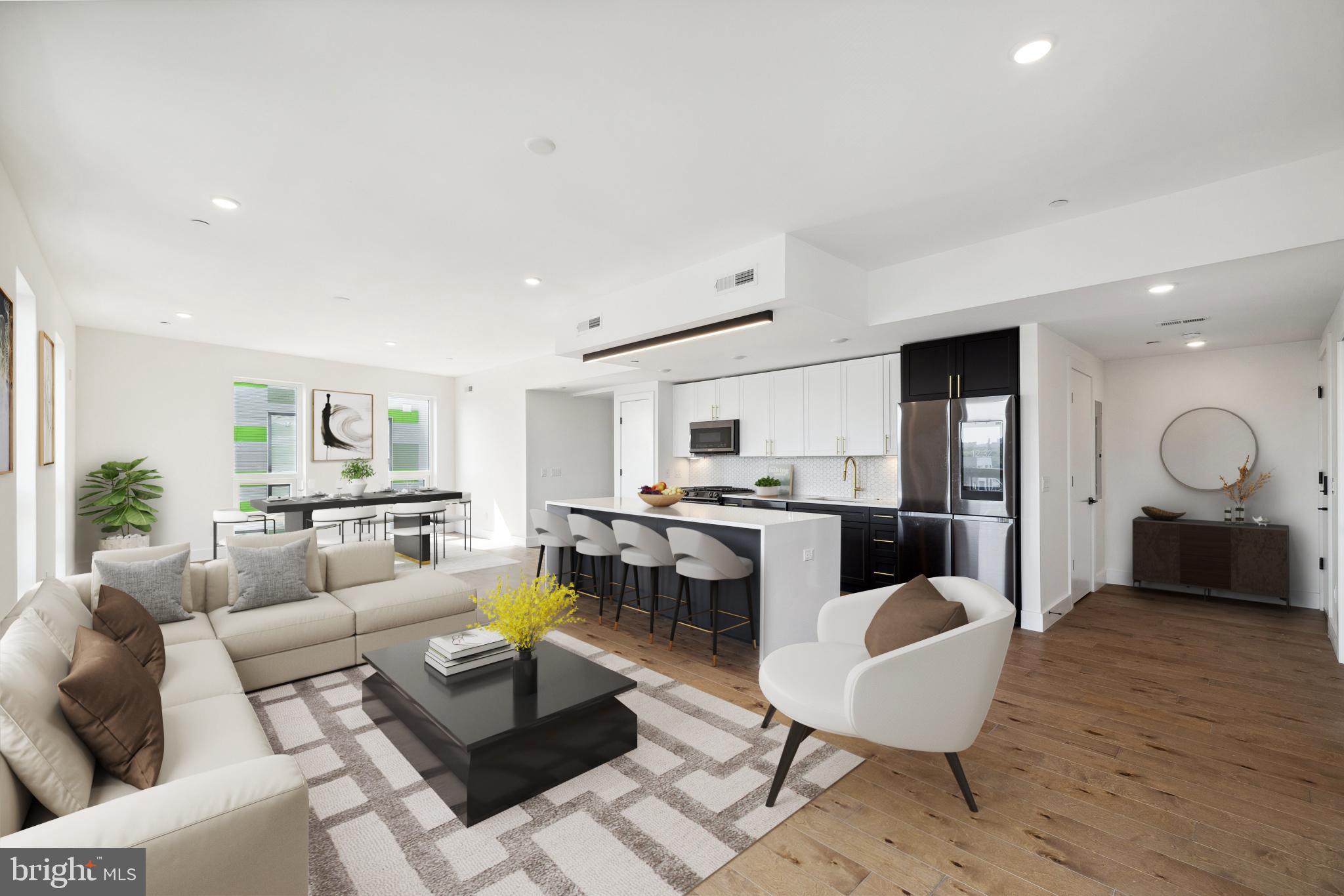 a living room with furniture kitchen view and a table