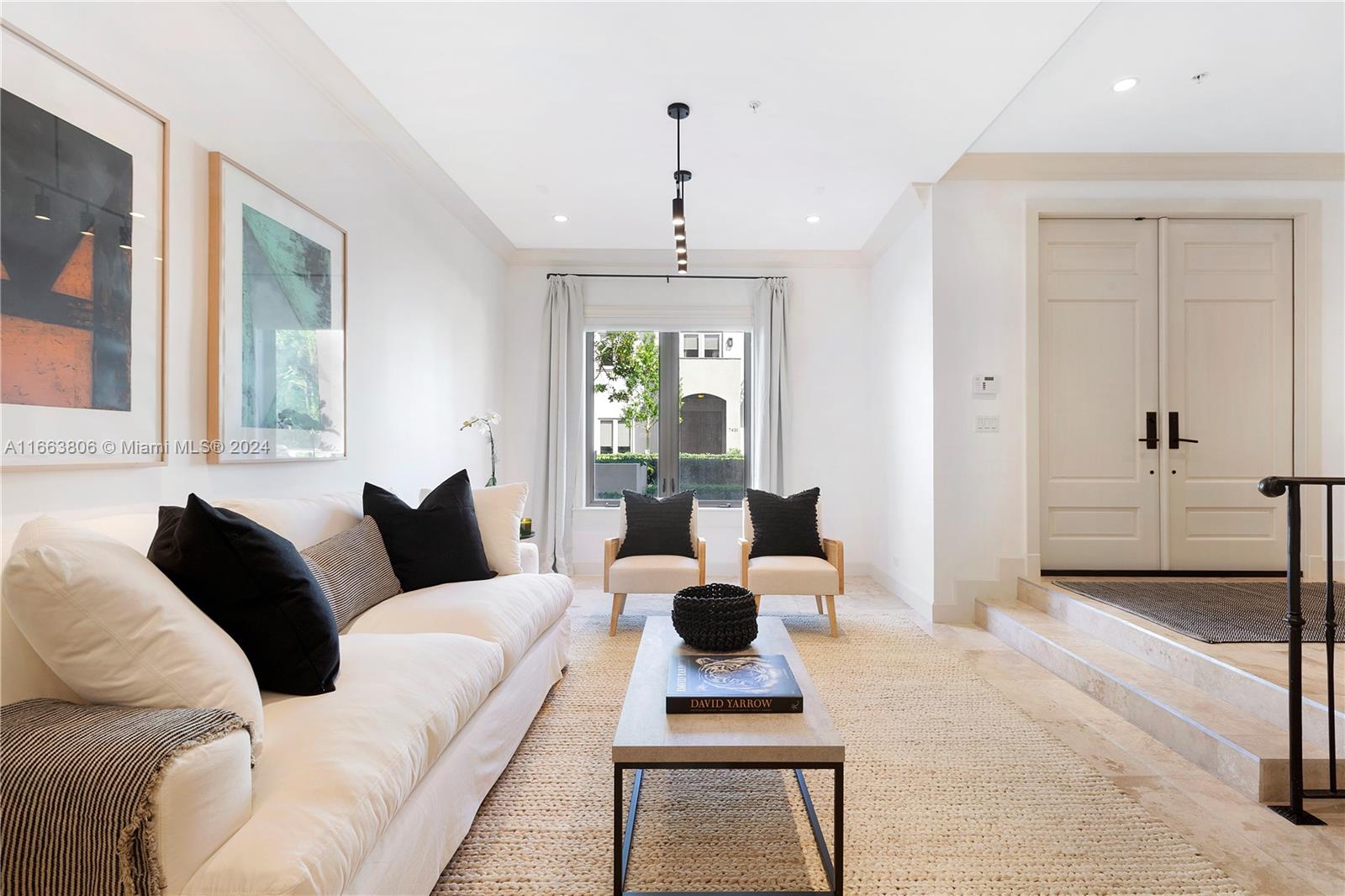 a living room with furniture and a chandelier