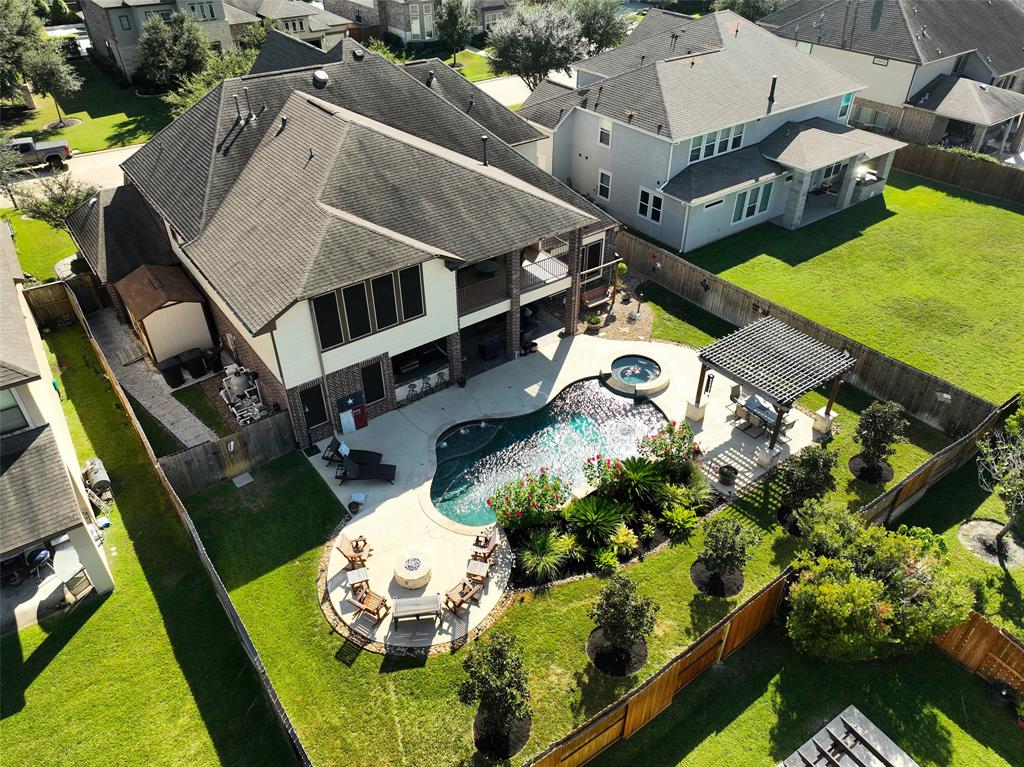 an aerial view of a house with a yard basket ball court and outdoor seating