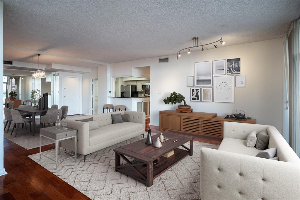 a living room with furniture and wooden floor