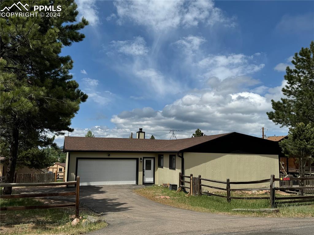 Single story home featuring a garage