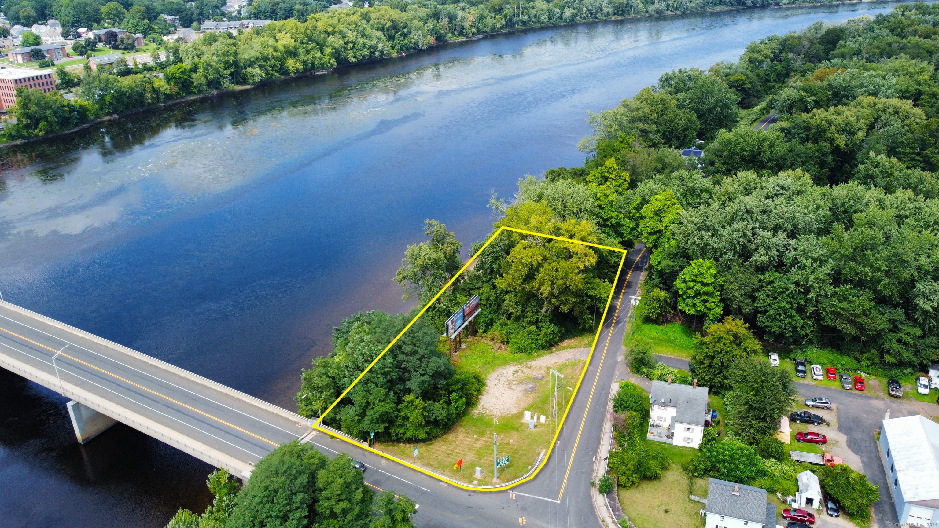 an aerial view of a house with garden space and lake view