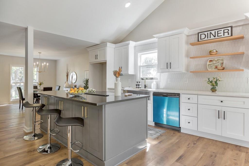 a kitchen with a sink cabinets and dining table chair