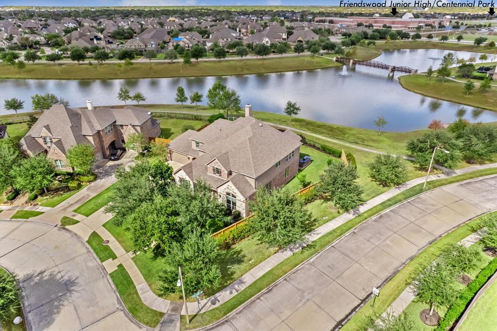 an aerial view of a house with outdoor space and lake view