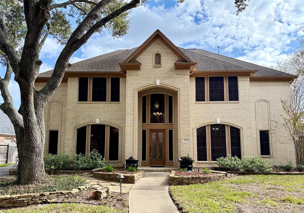 a front view of a house with yard