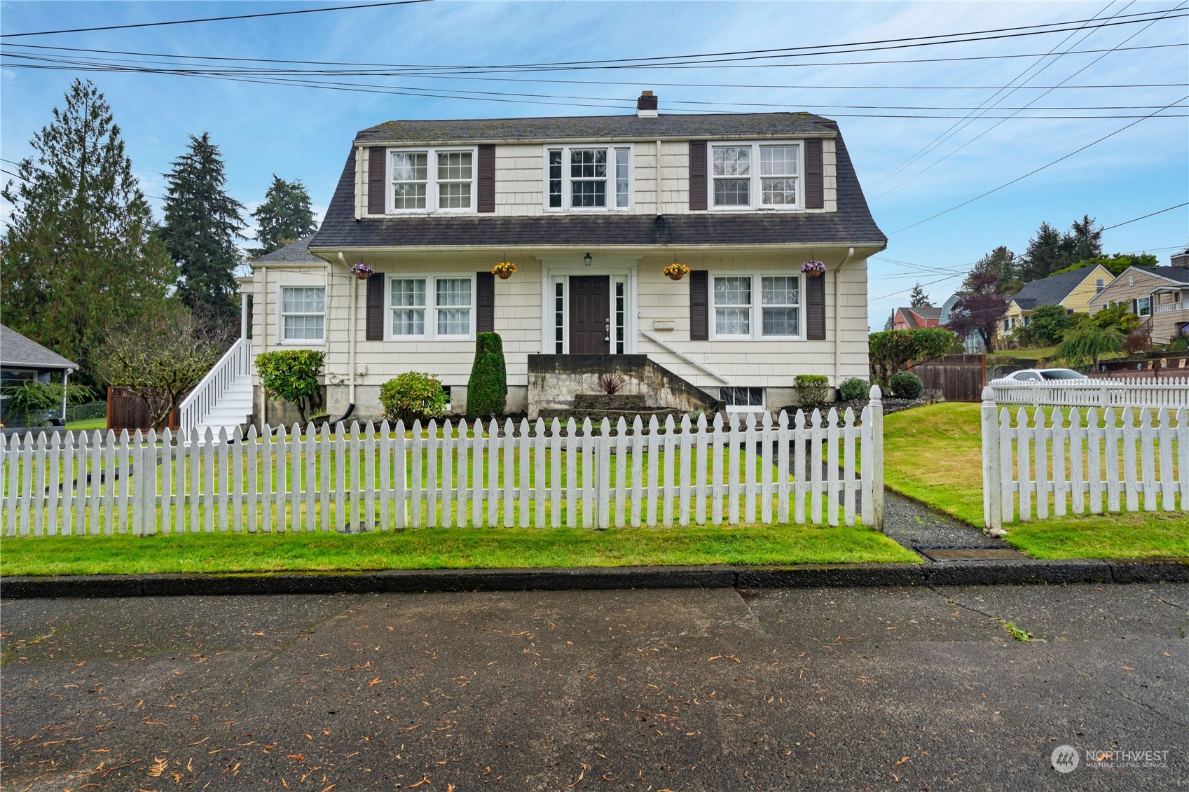 a front view of a house with a garden