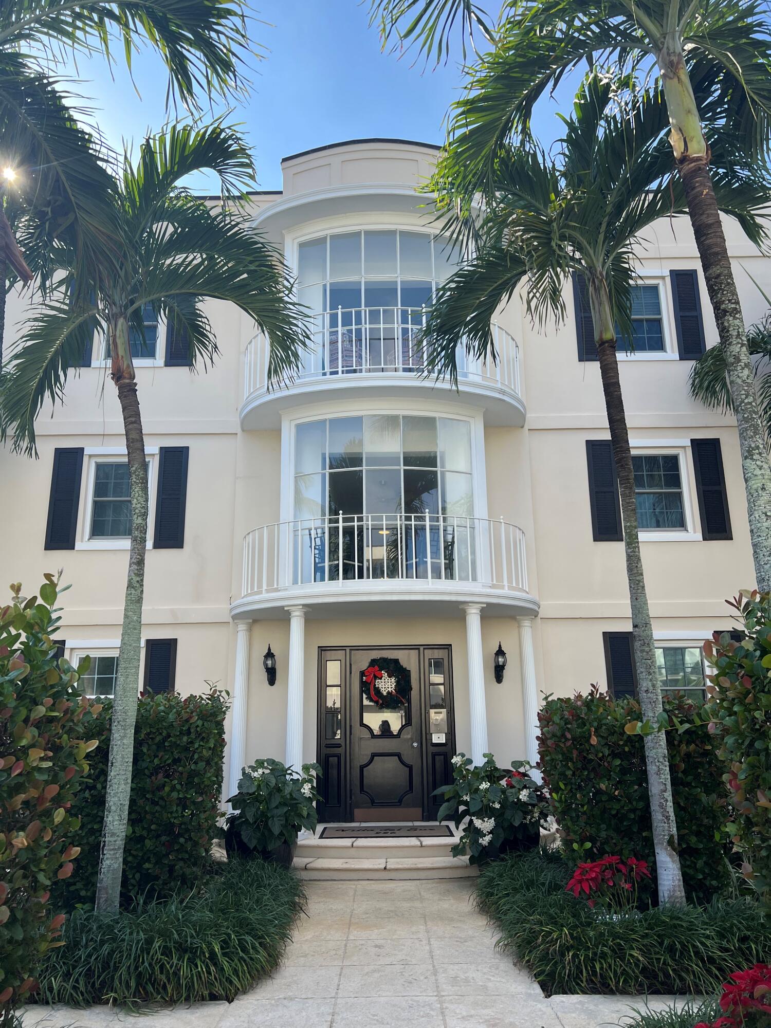 a front view of a multi story building with yard