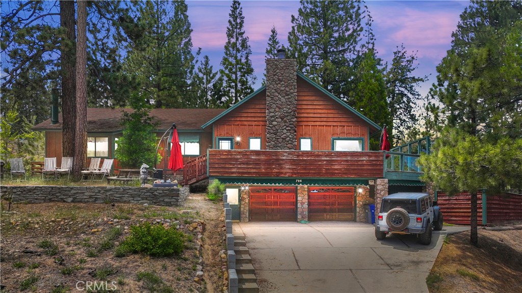 a view of a house with a yard and sitting area