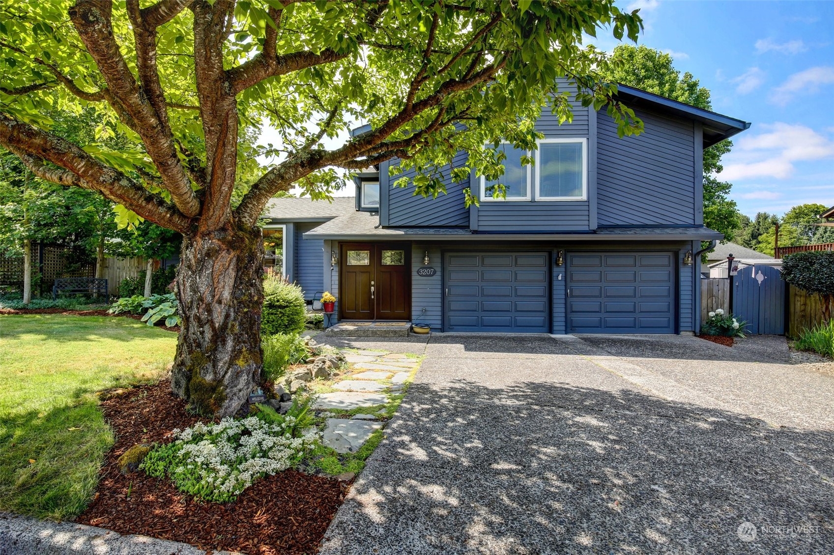 a front view of a house with a yard and garage