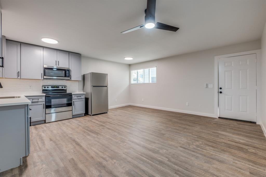 a view of kitchen with microwave and cabinets