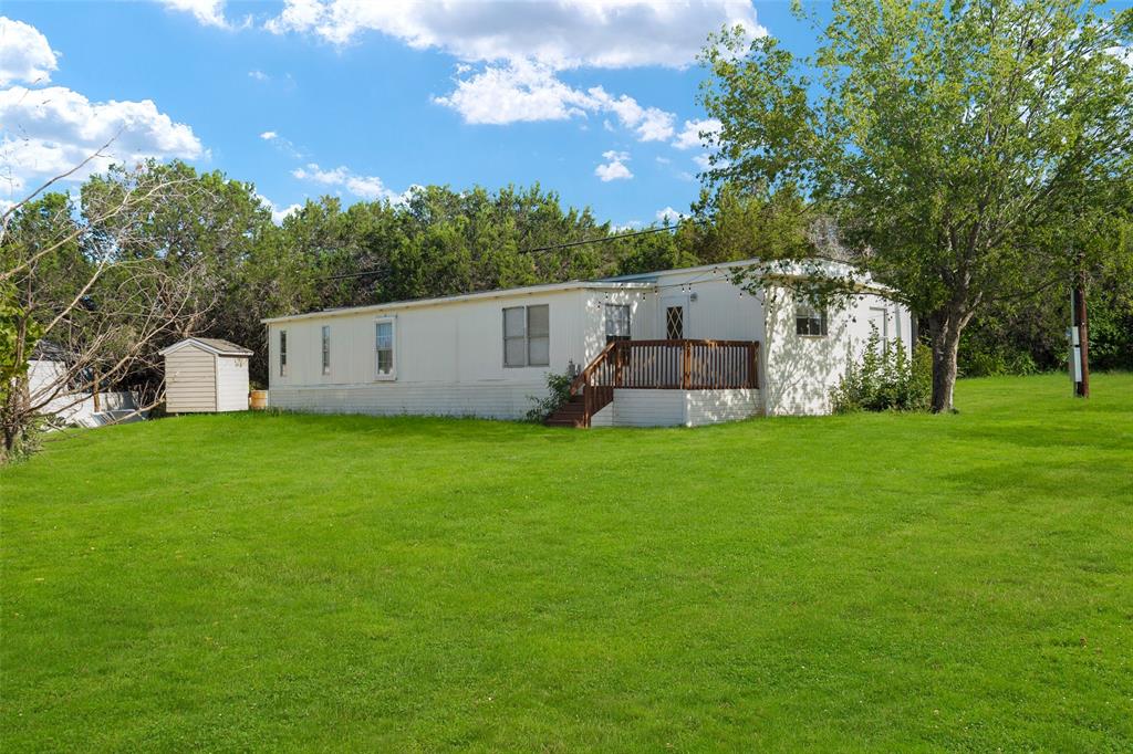 a view of a house with backyard and sitting area