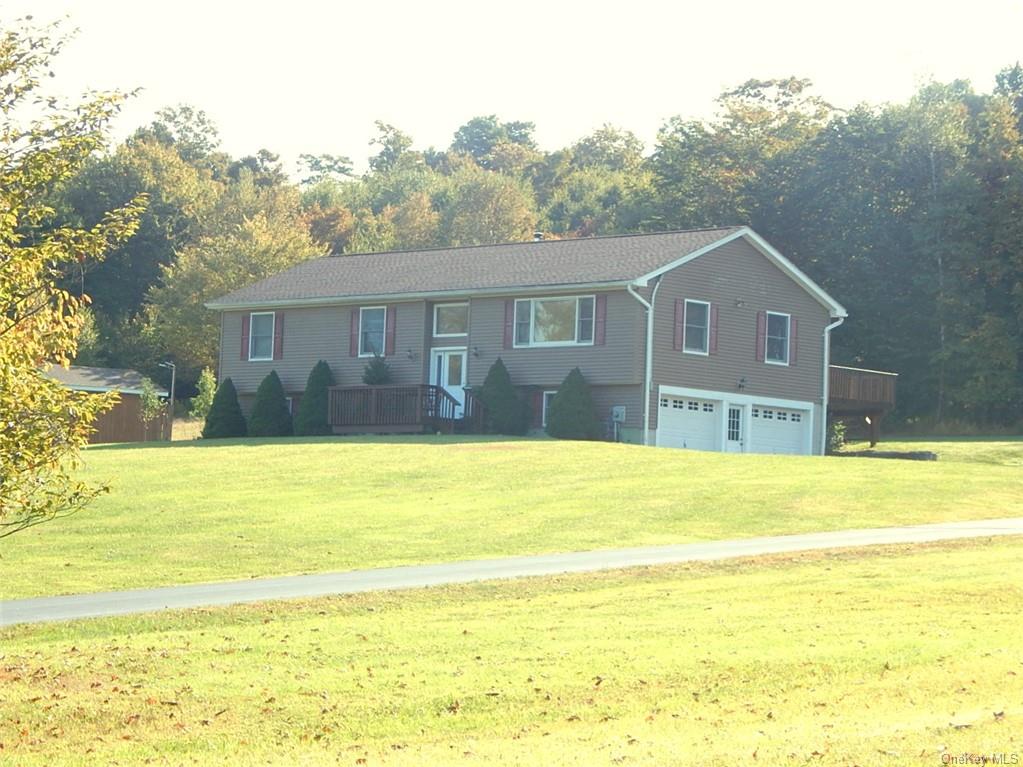 a view of a house with a backyard