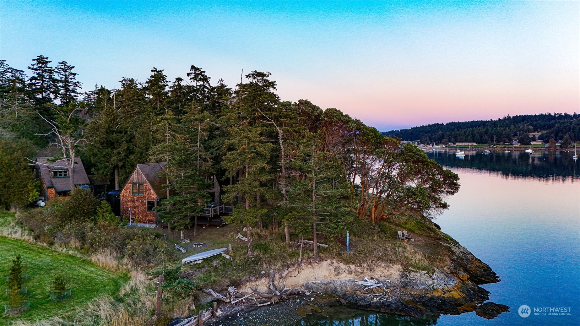 a aerial view of a house with a yard and lake view