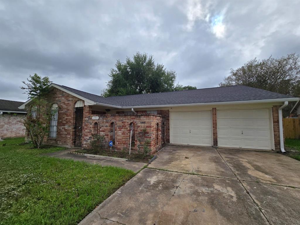 a view of a house with a yard and a garage