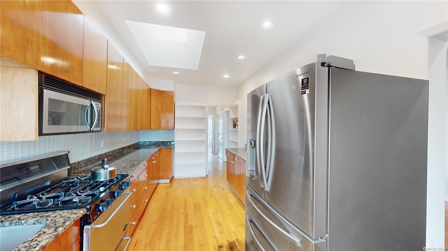 a view of a kitchen with a refrigerator and a stove