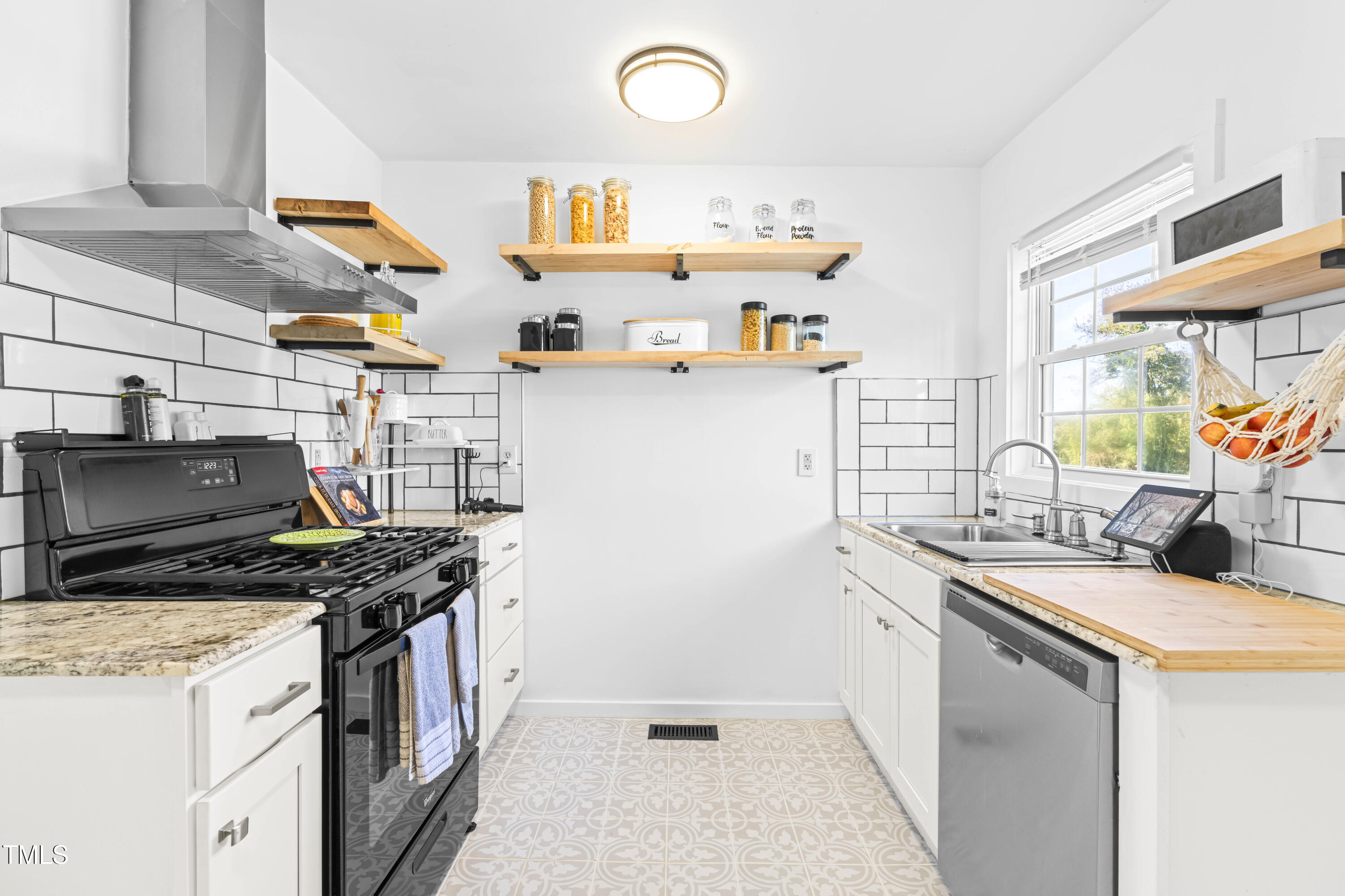 a kitchen with stainless steel appliances granite countertop a sink stove and cabinets