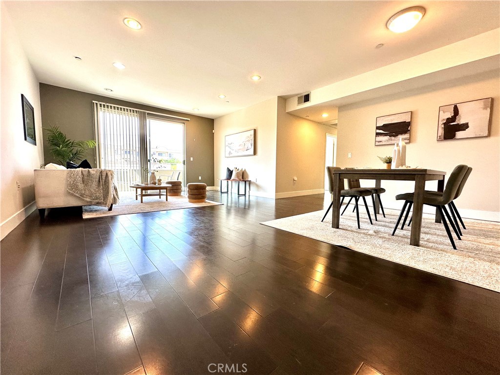 a view of a dining room with furniture and wooden floor