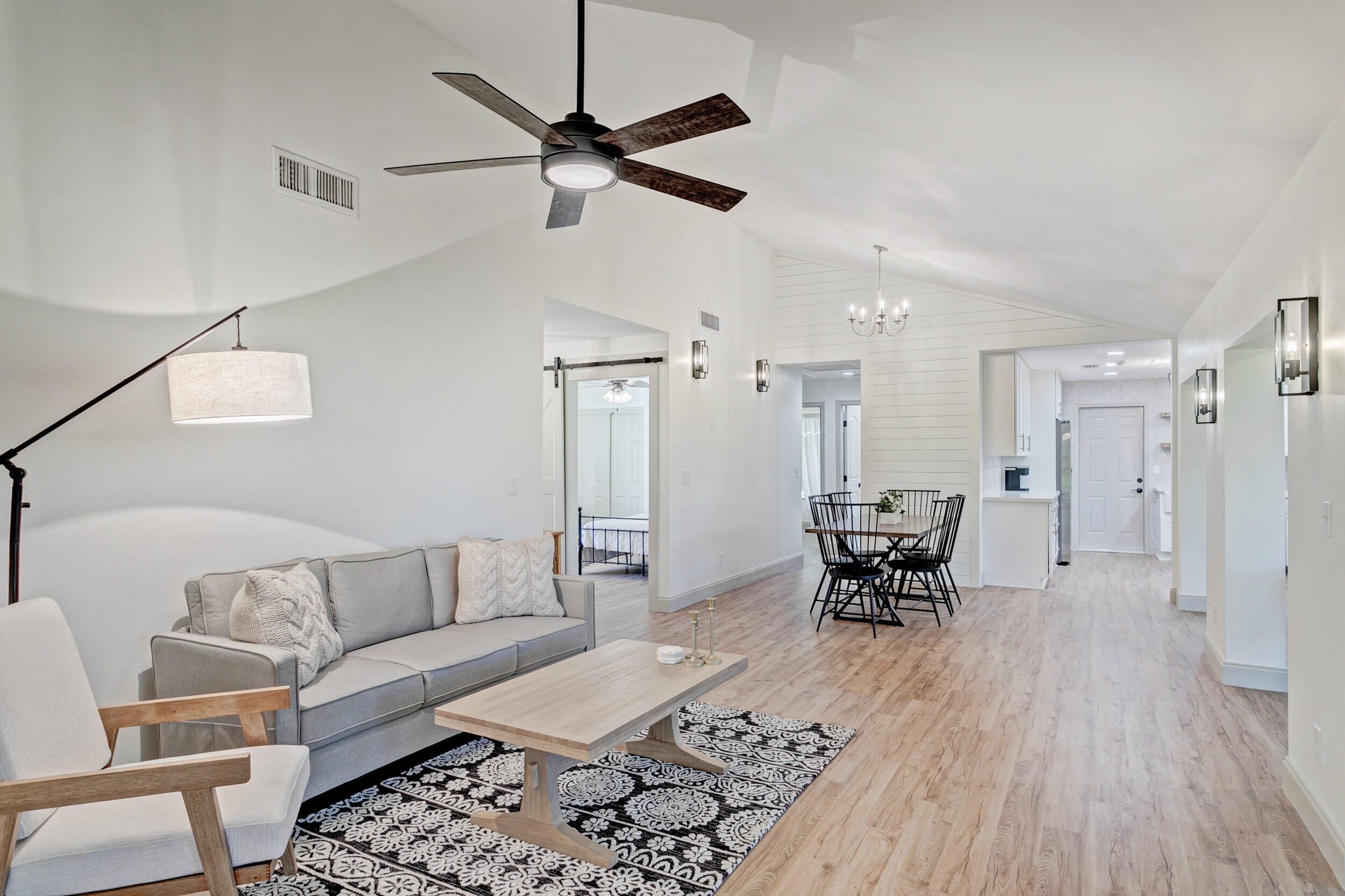 a living room with furniture and a wooden floor