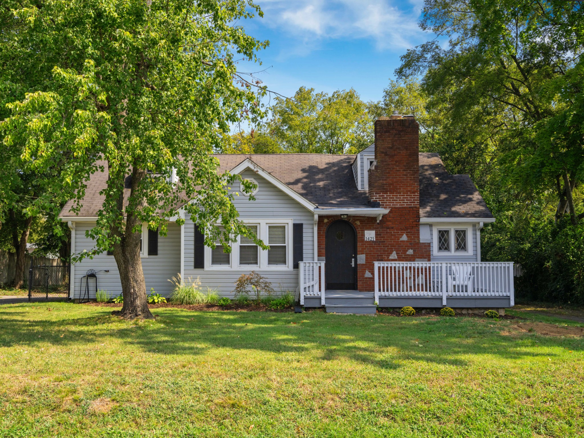 a front view of house with yard and green space